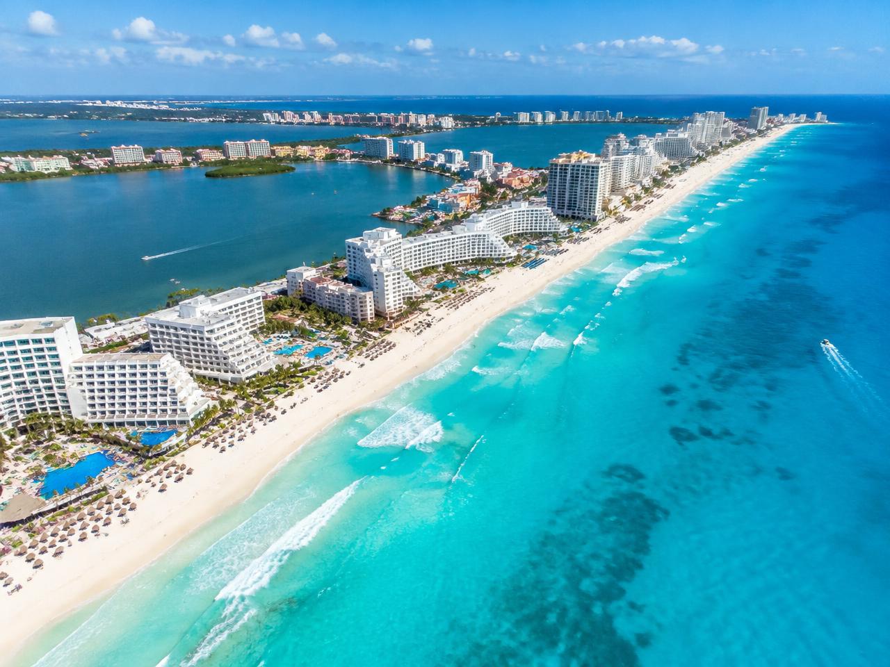 Aerial view of a turquoise Caribbean coastline with beachfront resorts